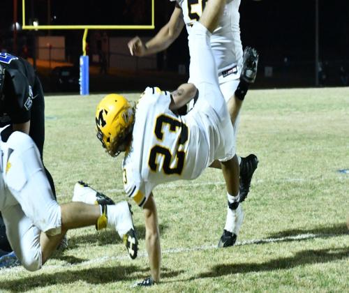Left: Junior Kendall Robertson, #4, runs the ball while Senior Armando Sanchez, #50, follows. Right: Sophomor Holden McGahey, #23, hits the ground during the Madill v. Little Axe game on November 5, 2020. Jennifer Rushing