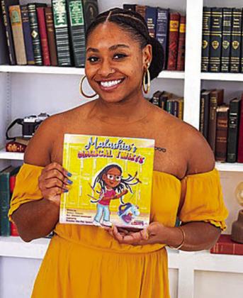 Hailey Robinson poses with her book “Malashia’s Magical Twists,” which is available on Amazon, Apple Books and at Barnes and Noble.. Courtesy photo