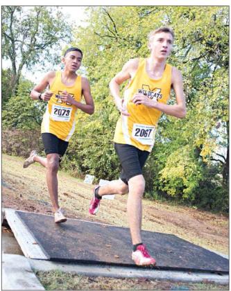 Photos by Brian Blansett for The Madill Record Bottomleft:Madillsophomore Anthony Sanchez (2073) and senior Chris Bennett (2067) run in the 2019 4A OSSAA State Championship Cross Country Meet on Oct. 26.