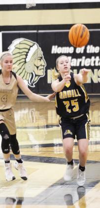 Madill sophomore guard Destiny Adams makes a pass to a teammate in a Feb. 17 game at Marietta. Glenn Price • The Madill Record