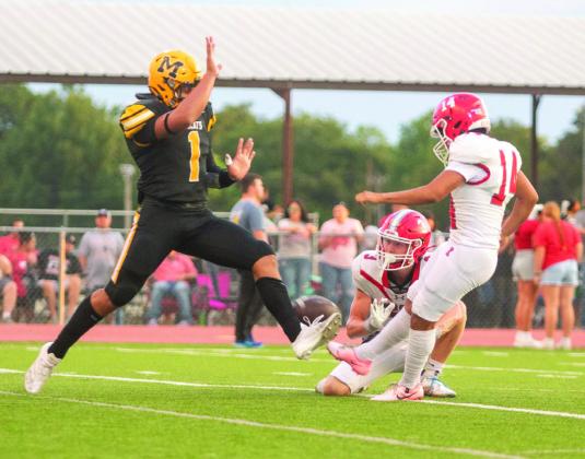 Wildcat Kris Grimaldo blocks an extra-point attempt by Redskins Jaime Lewis. Courtesy photos