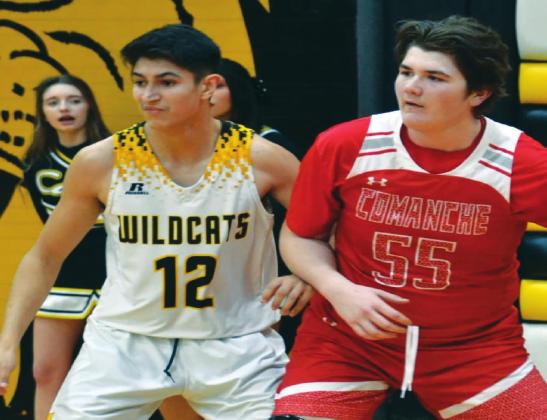 Yoyo Robles squares off with a Comanche Indian during the January 26, game. Unfortunately, the Wildcats lost 37 to 25. Summer Bryant • The Madill Record