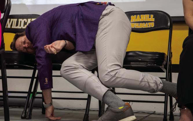 Hypnotist Michael Mayo had participants snuggle up on each other and some were so relaxed, they laid on chairs. Photo courtesy of Matt Swearengin