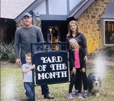 Bradley and Jennifer Martens, along withAudrey and Wyatt, stand in their Yard of the Month. Courtesy photo