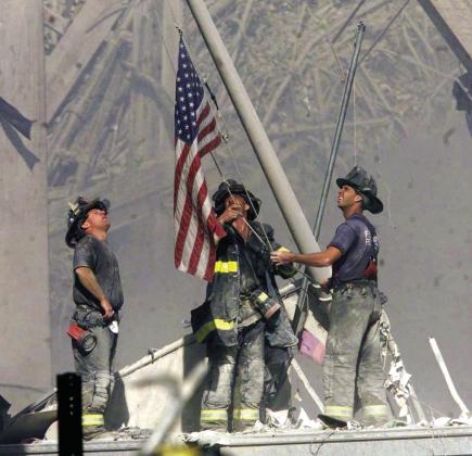 Firefiighters hoist the American Flag to begin the annual 9/11 Walk to honor those who were lost in the Twin Tower attacks in 2001. Courtesy photo