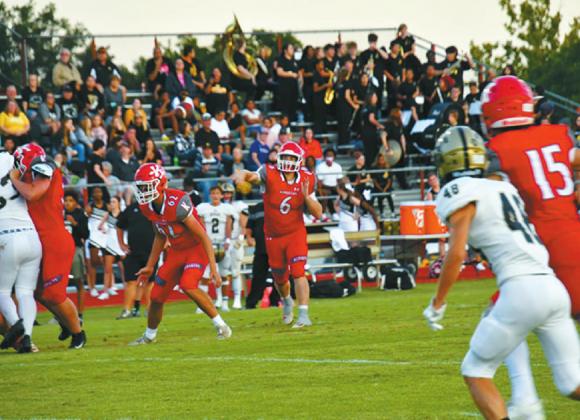 Kingston quarterback Jase Hayes (#6) releases his second touchdown pass of the night to receiver Braden Matchen (#15) with Hugo’s Jared Wallace (#48) in coverage. Linda Holmes