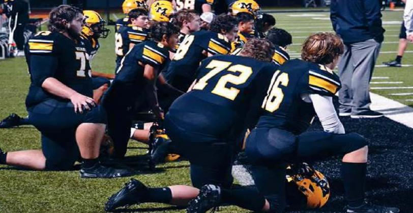 The Madill Wildcats stopped everything and dropped to one knee to show respect to their fellow teammate, senior Griffon Williams when he was hurt. Summer Bryant • The Madill Record