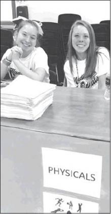 Courtesy Photo Madill Sophomore Emily Ortloff and Junior Ryleigh Combs assist with the enrollment event. It brought in over 1,500 people.
