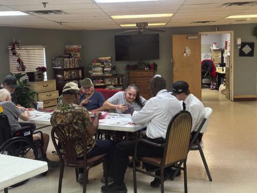 Pictured left - From left to right: Belinda Geter, Tim Davis, Nathan Stewart, Charlie Beverly and Darrell Davis. Pictured right - guests enjoy playing Bingo at the event. Courtesy photos