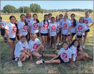 The Madill Middle School boys xc team, left, and the girls xc team, right, both took first place in the ECU Tiger Chase meet on September 8. The winning teams received special shirts. Courtesy photos