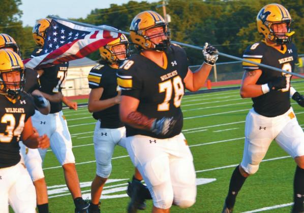 Jorge Martinez, Tito Martinez, Griff Williams, Ty Rushing and the Madill Wildcats ran onto the field carrying an American flag before kick-off at the Madill v. Enid game. Unfortunately, the Wildcats lost 63-0 to the Enid Plainsmen. Summer Bryant • The Madill Record