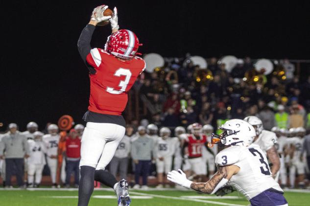 Eli Oliger leaps in the air to catch a pass during the Kingston v. Marlow game. Matt Swearengin