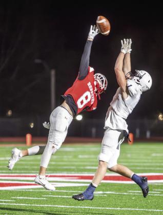 Hudson Everhart and a Marlow Outlaw both reaching to catch a pass. Matt Swearengin
