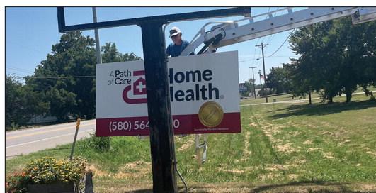 A familiar sign on Highway 70 North is changing. Randy Rains from Sign Depot installs the sign for A Path of Care Home Health, the new name of Tendercare Home Health. Courtesy photo