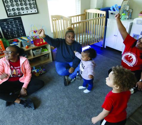 Jasmine Stewart, top right, participates in play time March 13, 2023 at her home-based childcare Jus Kid'N Learning Academy in Tulsa. Also pictured are, from left, Tarleace Johnson, Chant'e Stewart, Lynnox Mickey and Kason Grey. Rip Stell • Oklahoma Watch