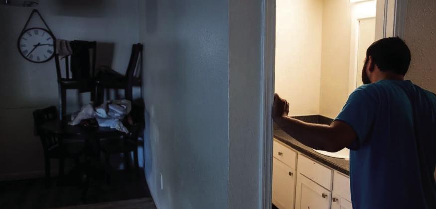 A 28-year-old Afghan refugee who served U.S. interests in his country as a member of the CIA-backed Kandahar Strike Force looks into the only working bathroom of his northwest Oklahoma City apartment, where the ceiling leaks while the water runs. To his left, a donated table and chairs are stacked in the corner because his family customarily sits on the floor to eat over a smaller surface. Brooks Sherman • Oklahoma Watch