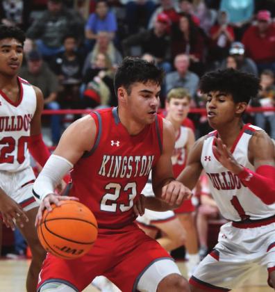 Brady Brister dribbles down court while fighting off the Sulphur Bulldogs. Unfortunately, the Redskins lost 38 to 57.. Crockett Uber