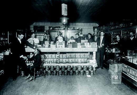 Dr. Lewis, front left, examining a child in the Will Courtney Drug Store in Kingston about 1905-1907. Courtesy photo
