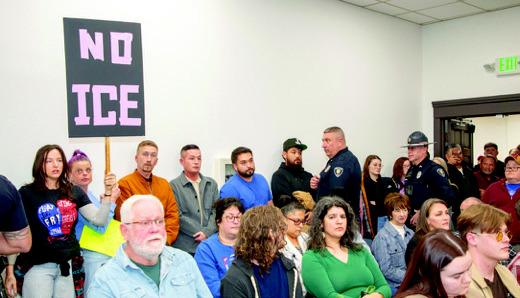 Durant Deputy Police Chief Joe Clark and another officer approach a man who was speaking out during a city council meeting as council members were preparing to vote on an ordinance that would require a conditional use permit for a detention center. Matt Swearengin