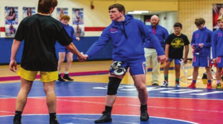 Payton Thomas (right) shakes hands with his opponent before a wrestling match at USA Wrestling’s Brian Keck Memorial Preseason National Tournament in Des Moines, Iowa. Courtesy photo