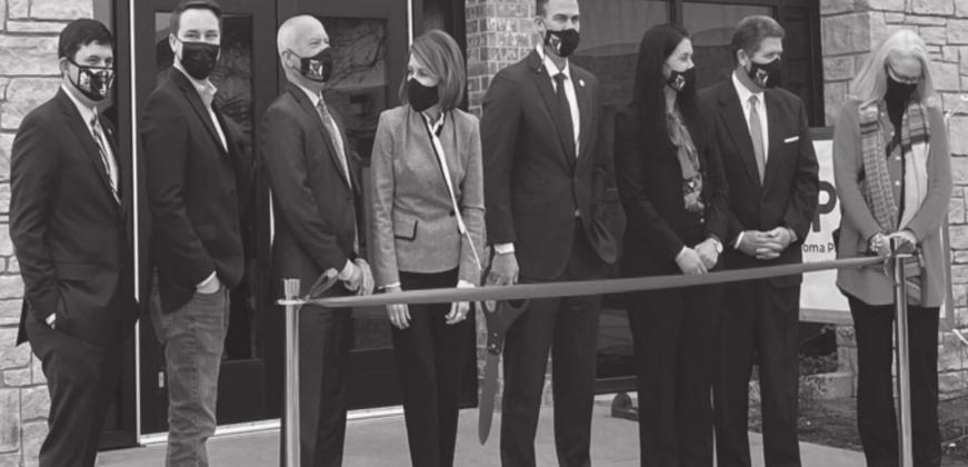 Oklahoma Gov. Kevin Stitt, center holding scissors, and state cabinet secretaries pose during a Jan. 21 ribbon-cutting ceremony at the newly relocated state Public Health Lab in Stillwater. Oklahoma State Department of Health