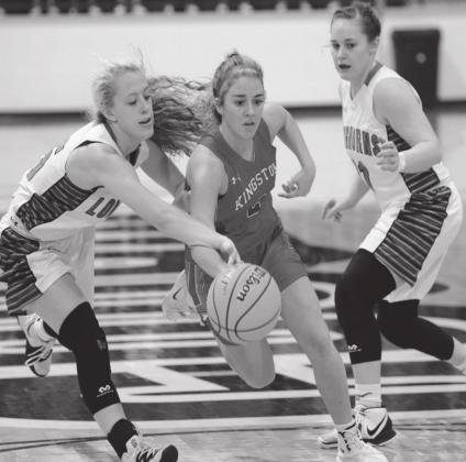 Ryan Herndon dribbles through two defenders during the game against Jones on March 5, 2021. The Lady Redskins lost 66 to 31, but were still able to advance in the tournament and ultimately advance to state. Crockett Uber
