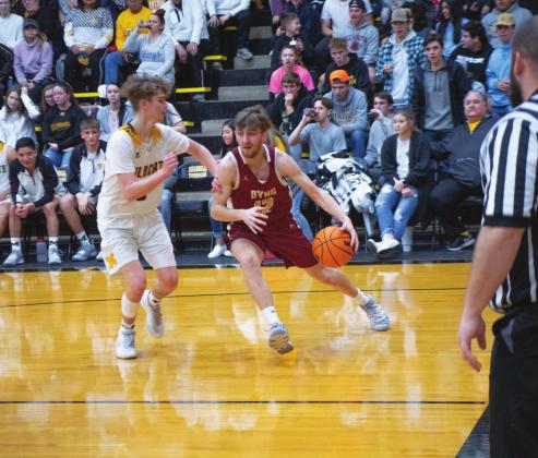 Madill senior guard Austin Maxey (left) guards a Byng player in their game Feb. 11. The host Wilcats won the game 58-51. Lony Dorman • The Madill Record