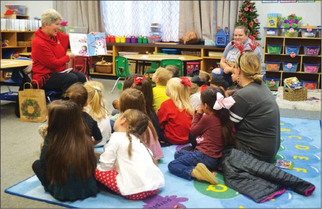 Matt Caban • The Madill Record Ann Hartin reads to students in Mrs. Patton’s Pre-K grade class during meet Santa Claus during the Madill Public Schools’ Eighth Annual Joyce Coleman Christmas with the Kids Dec. 17 at the Madill Early Childhood Center.