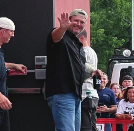 Blake Shelton waves to his adoring fans after he and his wife, Gwen Stefani, put on an impromptu concert on July 15 and 16. Tom Stewart
