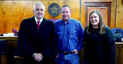 Nick Hartin was sworn in as County Commissioner for District 2, on February 21 by Judge Johnson. Pictured: Judge Johnson, Nick Hartin &amp; wife, Betsy Hartin. Courtesy photo