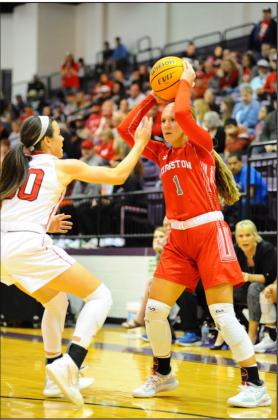 Kingston’s Presley McKnight looks to pass the ball around a Comanche defender during the teams’ March 7 game in Chickasha. Crockett Uber • The Madill Record