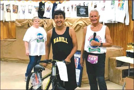 Courtesy Photo Jose ‘Nacho’ Angulano was the winner of the girls’ bike, which was presented to her by the event’s host, Dan Little.