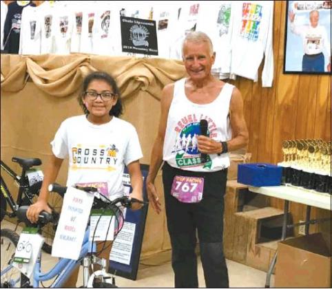 Courtesy Photo Onelia Stumblingbear, the winner of the girls’ bike, which was presented to her by the event’s host, Dan Little.
