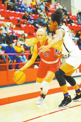 Lony Dorman • The Madill Record Kingston’s Britt Henderson (13) tries to drive past a Hugo defender during the teams’ Regionals game Feb. 27. The Lady Redskins prevailed 57-44.