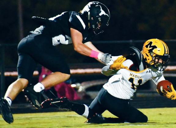 RJ Morris fights to get out of the clutches of a Longhorn player in the Madill v Lone Grove game on October 23. Unfortunately, the Wildcats lost 53-13. Jennifer Rushing