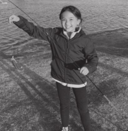 Meagan N. with a sunfish she caught at Wild Horse Park Pond in Mustang. Courtesy