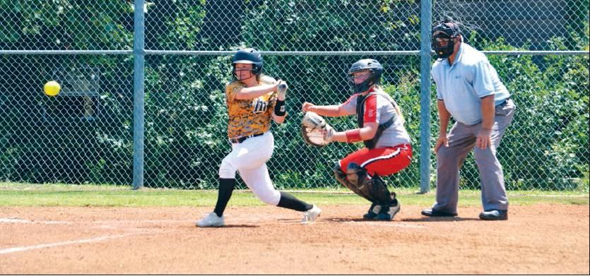 Matt Caban • The Madill Record A MEMBER of the Madill Lady Wildcats fast pitch team hits a pitch down the third base line during the first inning of a game against the Bennington Lady Bears on August 16. The teams played as part of the Calera Tournament.
