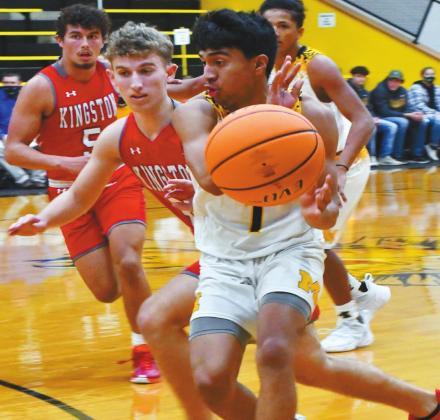 Madill’s Miguel Duran, #1, gets flanked by Kingston’s Tucker Rumer, #30 and Jesse Rose, #5 during the December 8 game. Aylin Salazar