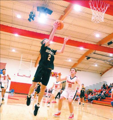 Madill senior guard/forward Wyatt Gray (2) scores a basket during a recent game against Comanche.