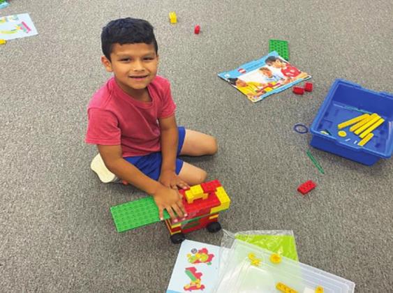 Alfredo Aldava creates with Legos during the ECC's Lego activity class. Courtesy photo