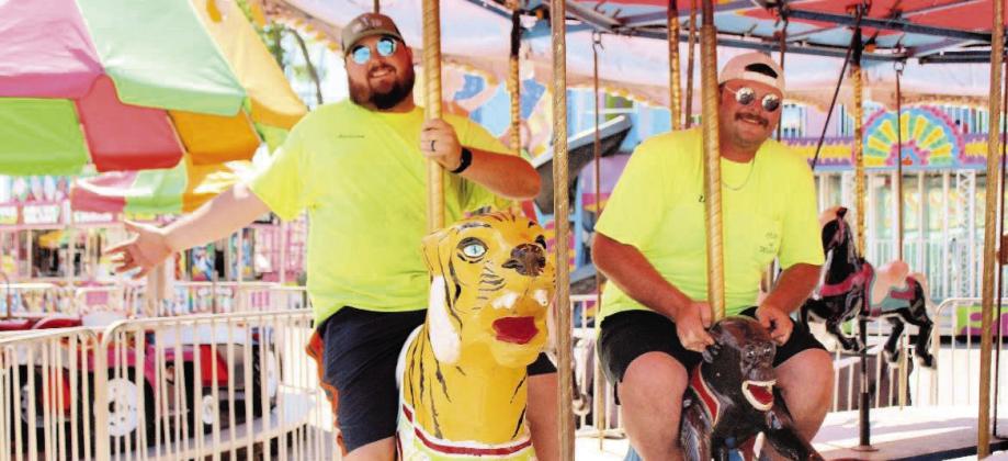 Addison Johnson and Zac Lee, both City of Madill employees, love what they do. They work hard all year and have fun during the National Sand Bass Festival. Photo by Summer Bryant