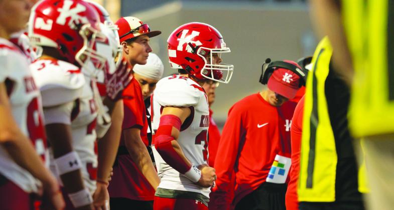 The Redskins stand on the sideline while watching their teammates on the field. Layton Corntassel