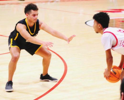 RJ Morris defends the ball during the Madill v Tishomingo game. The Wildcats beat the Indians 35 to 22 on January 11, 2022. Bre Eppler