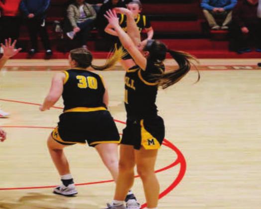 Jayden Weidberg shoots the ball while Lydia Landgraf defends. The Lady Wildcats beat the Lady Indians 60 to 39. Bre Eppler