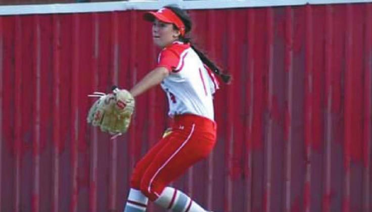 Junior Raegan Davis, #1 winds up to hurl the ball from the outfield to the infield. T.J. Harkins