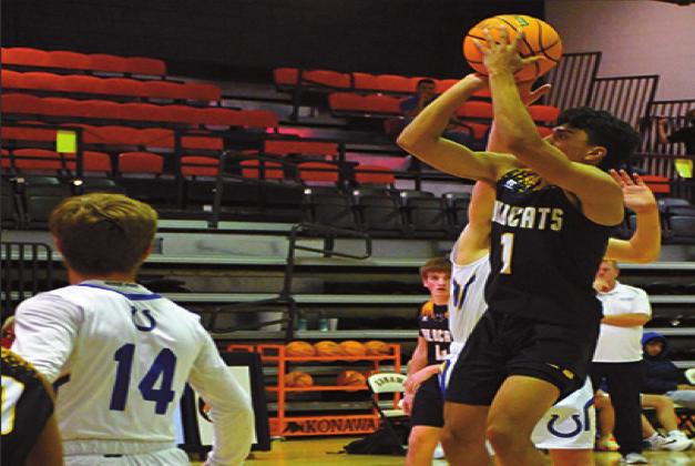 Miguel Duran scoring during the Wildcats v. Mustang game in the Konowa Basketball Tournament January 7 through 9. They beat the Mustangs to win the consolation round. Misty Thompson