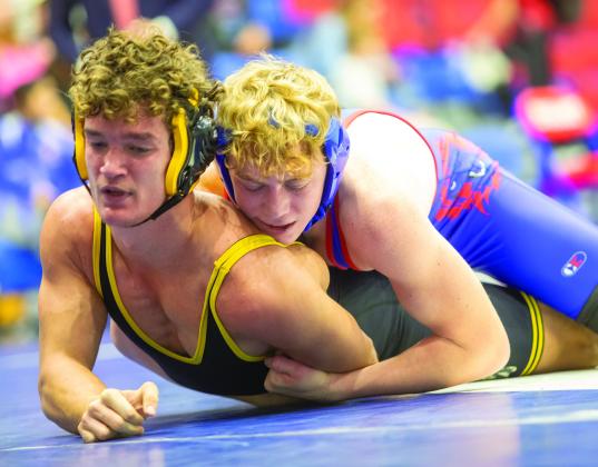 Left: Durant wrestler Chloe Marlow pins Madill wrestler Kadence Bourland. Right: Durant Lion Britton Trotter and Madill Wildcat Jaden McCain take to the mat. Matt Swearengin