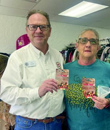 Jim Dowling hands Gwen Wilson two $400 gift cards for the Hope for Marshall County food pantry. Courtesy photos