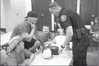 Courtesy Photo Community outreach and safety is a priority for the Lighthorse Police Department. Officers teach basic CPR during the youth police academy.
