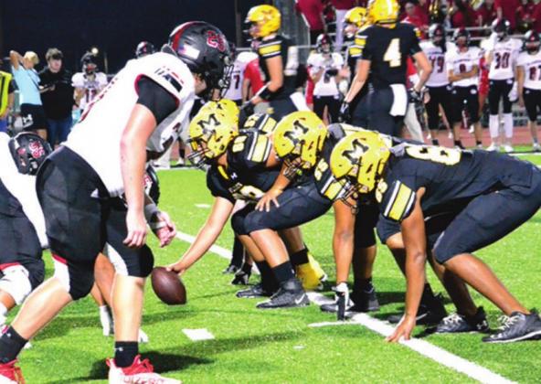 Madill gets ready at the line of scrimmage against Plainview. Unfortunately, they experienced their second loss of the season. Summer Bryant • The Madill Record